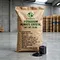 X-HUMATE 25kg potassium humate crystal organic fertilizer in eco-friendly kraft paper bag with clear English marks, featured with shiny black crystalline flakes in a glass beaker.